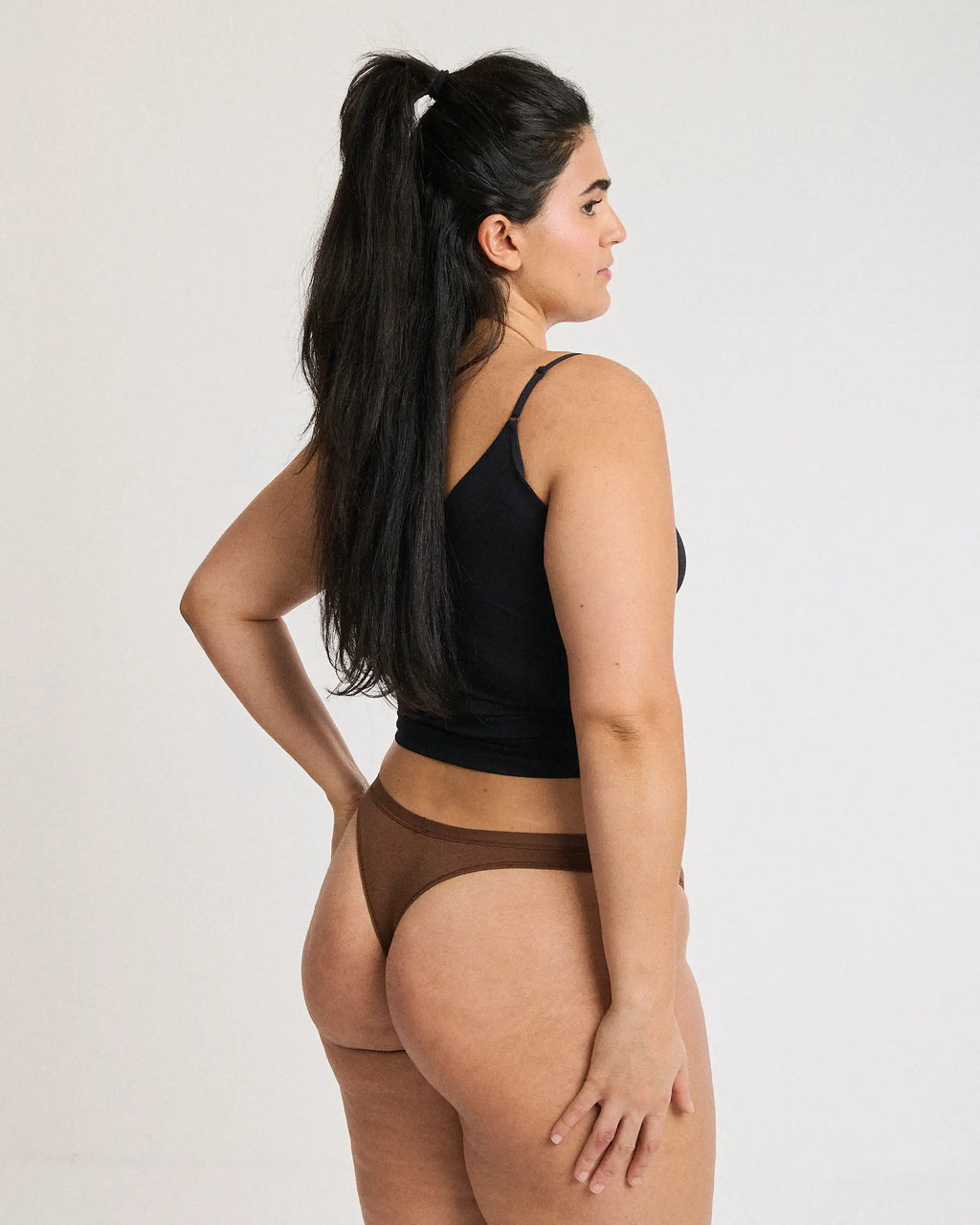 Side view of a woman wearing brown thong-style period underwear | Espresso