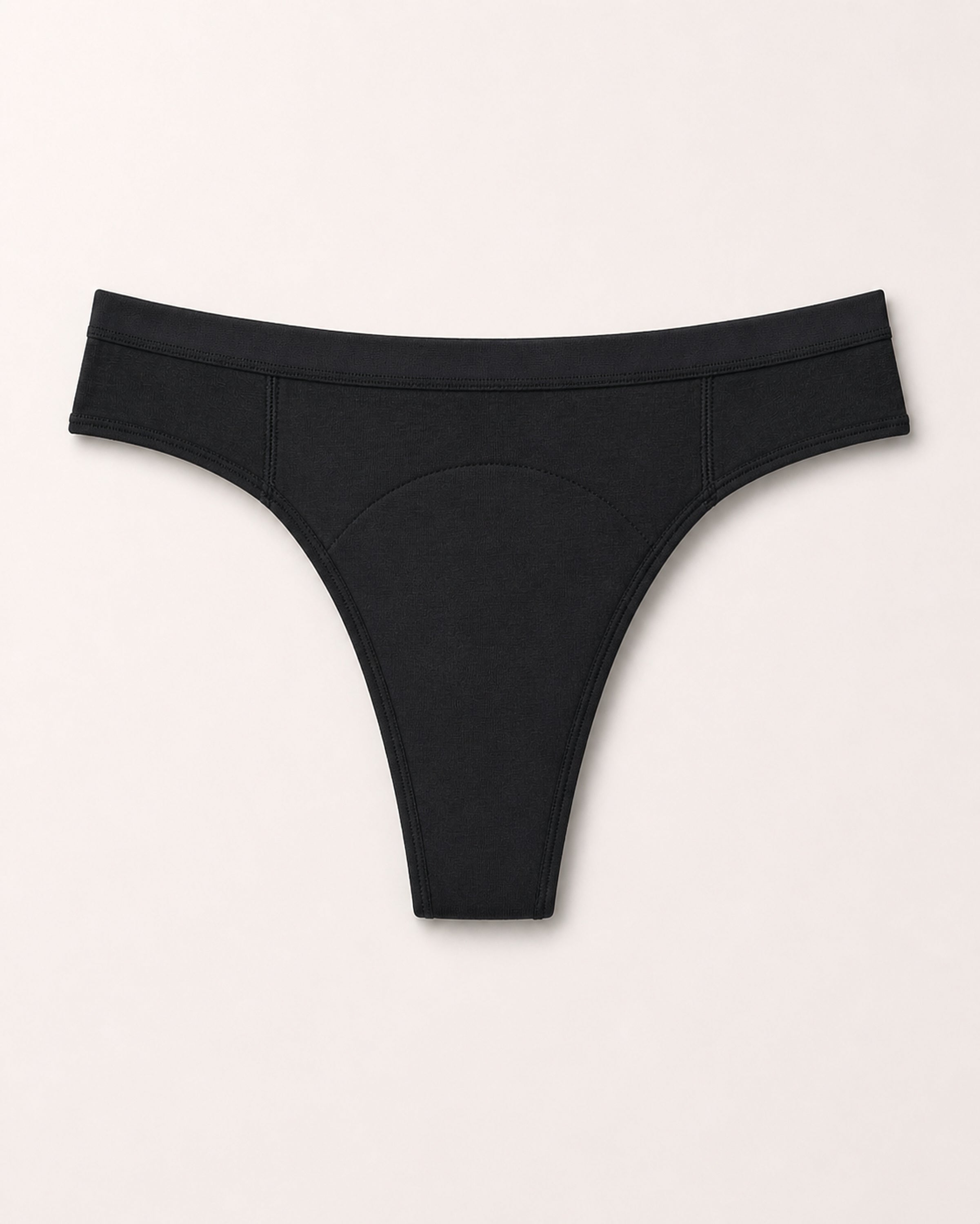 Black thong on a light beige background | Black
