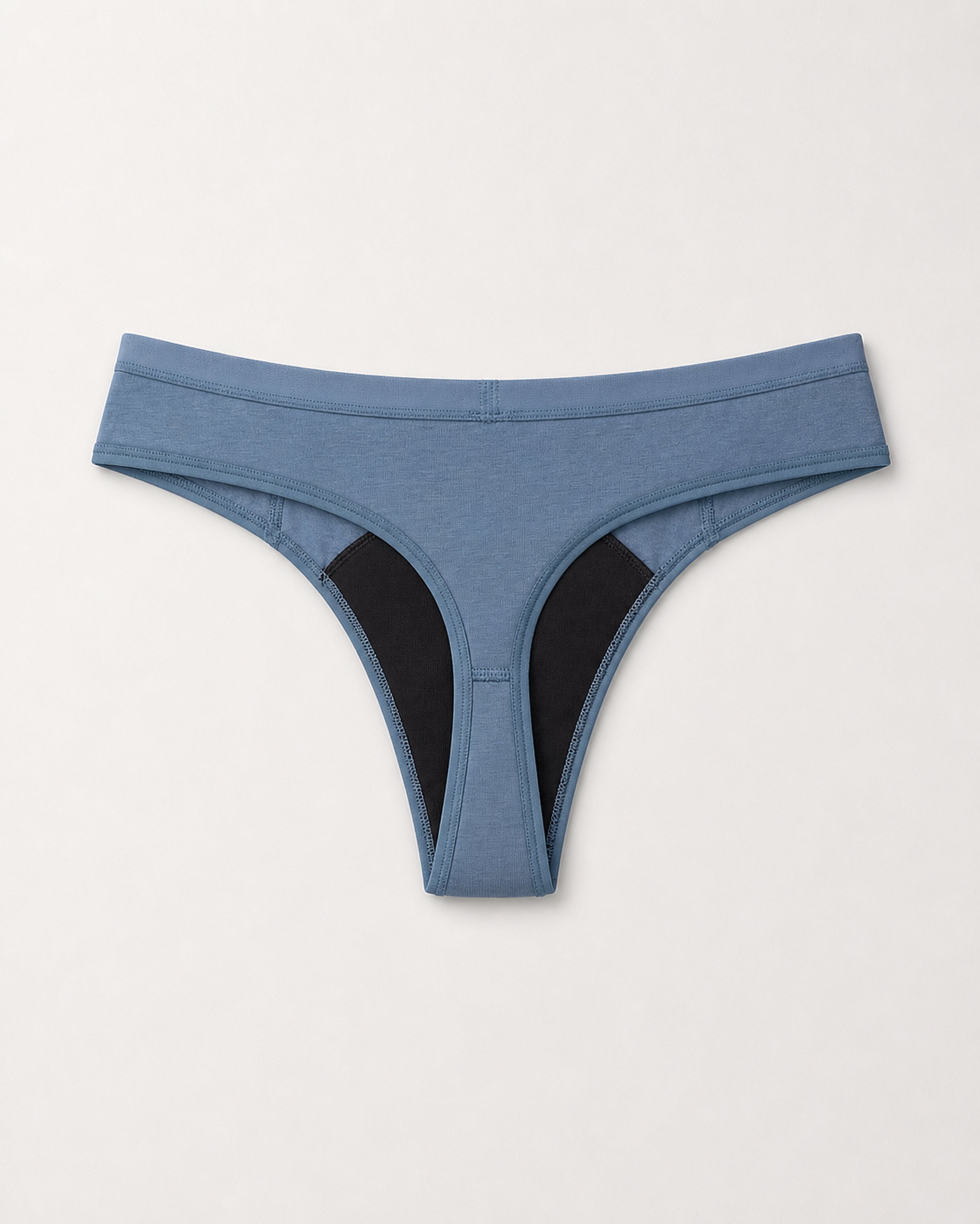 Blue thong with black accents on a light gray background | Denim